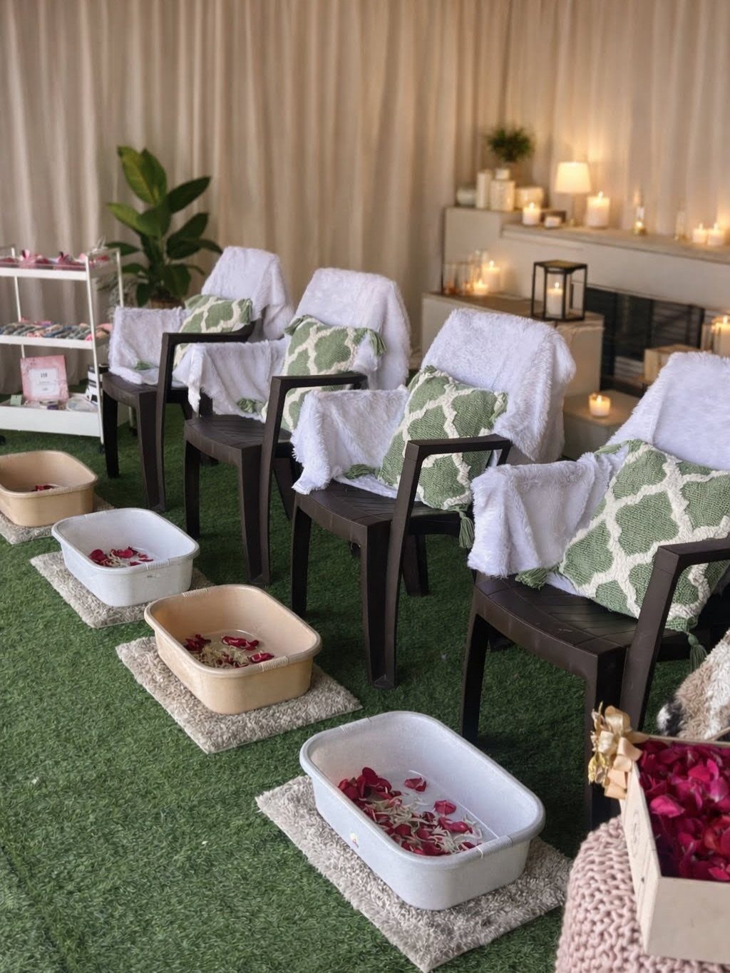 Spa setup with foot soak basins and lounge chairs for a birthday party