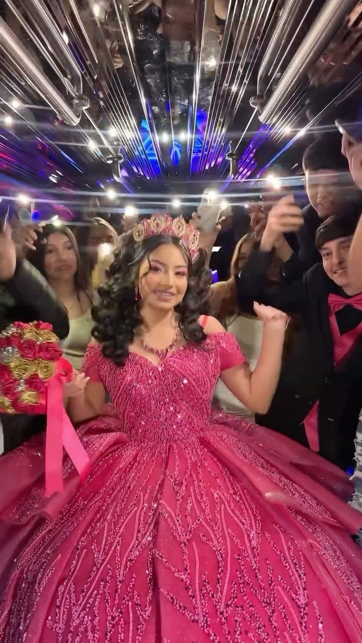 Young woman in pink ballgown and tiara posing inside a neon party bus.