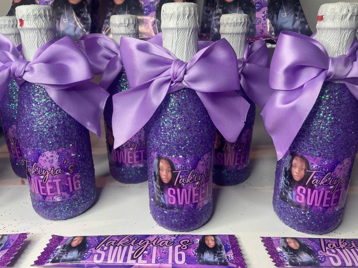 Purple glittery bottles with satin bows and personalized Sweet 16 labels.