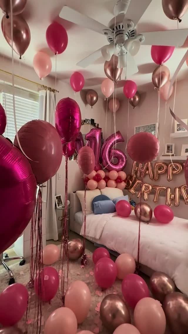 Pink and rose gold balloons with metallic number 16 balloons in a bedroom.
