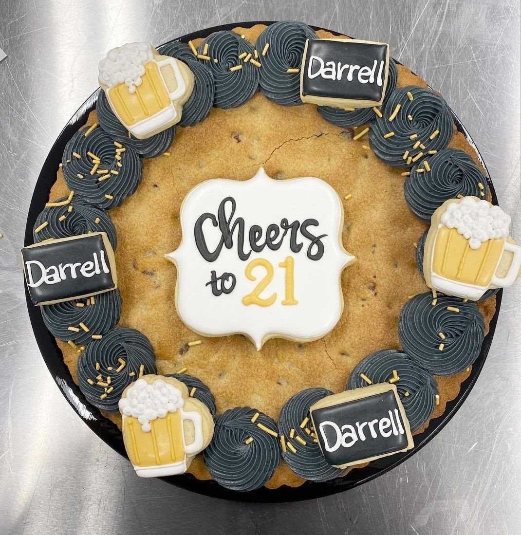 Round chocolate chip cookie cake with beer mug cookies and Cheers to 21 plaque