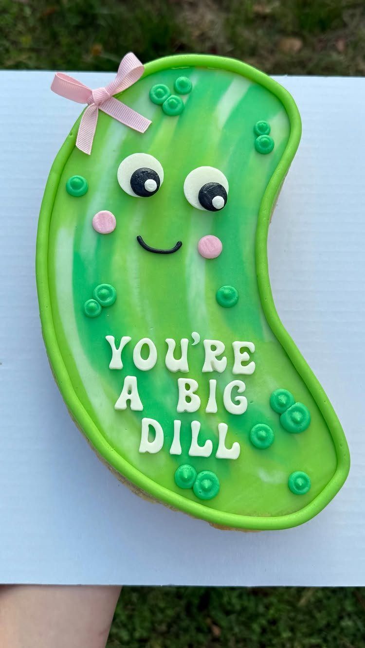 Pickle-shaped cookie cake with a smiling face and text saying You're a big dill.