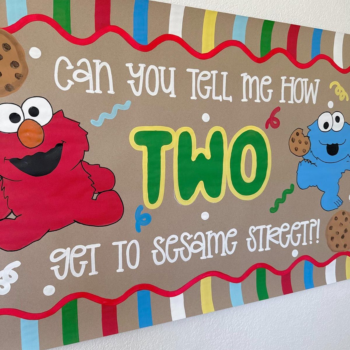 Hand-painted Sesame Street birthday banner featuring Elmo, Cookie Monster, and the word TWO.