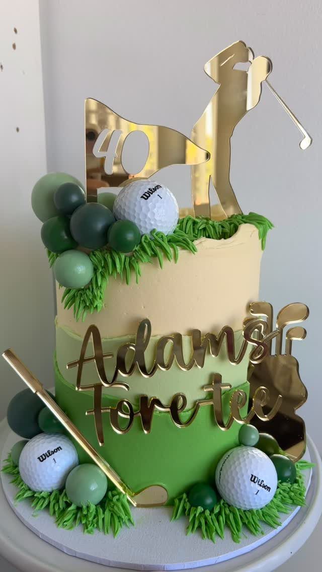 Golf-themed birthday cake with gold golfer topper, golf balls, and green frosting grass.