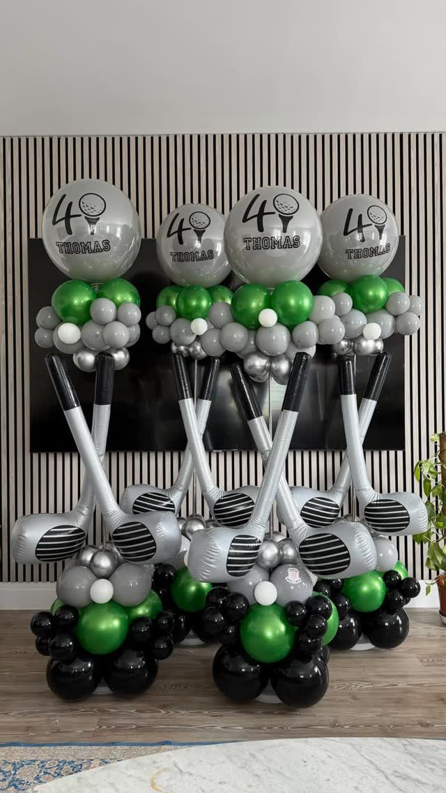 Golf-themed balloon decorations with silver clubs and balloons printed with 40 and Thomas