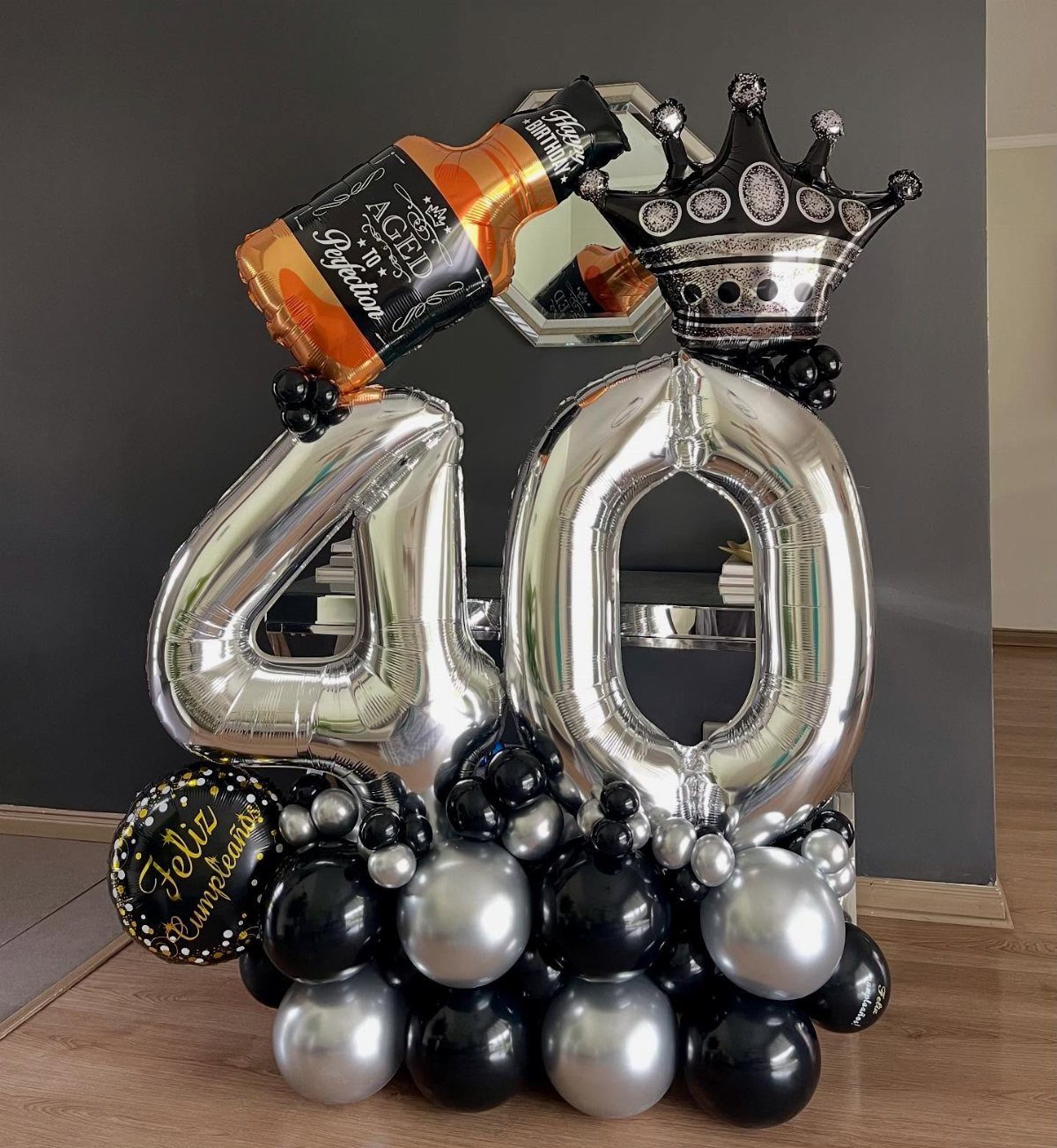 Silver number 40 balloons with a whiskey bottle balloon and black crown balloon.