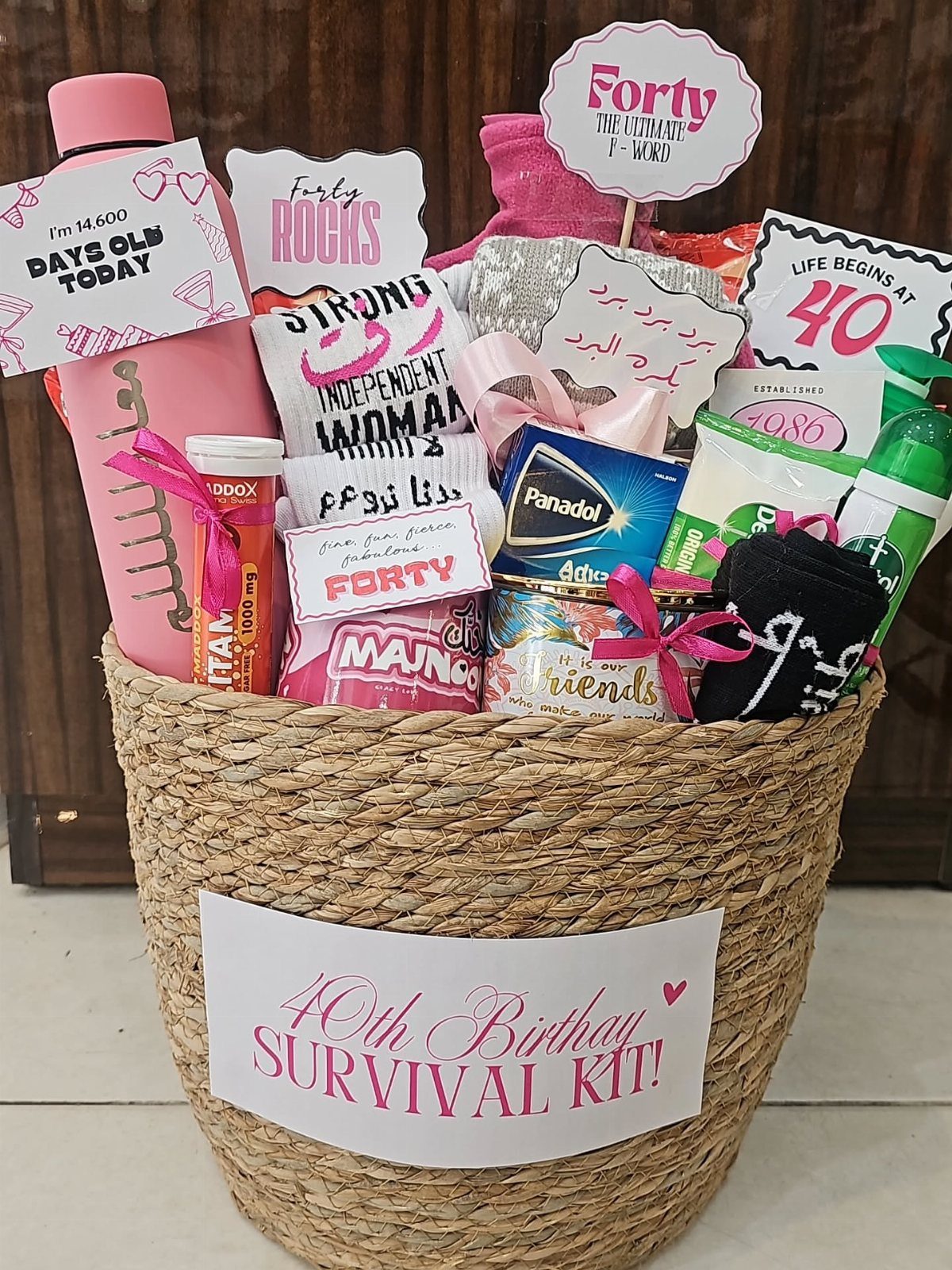 Woven basket filled with survival kit items for a 40th birthday celebration.