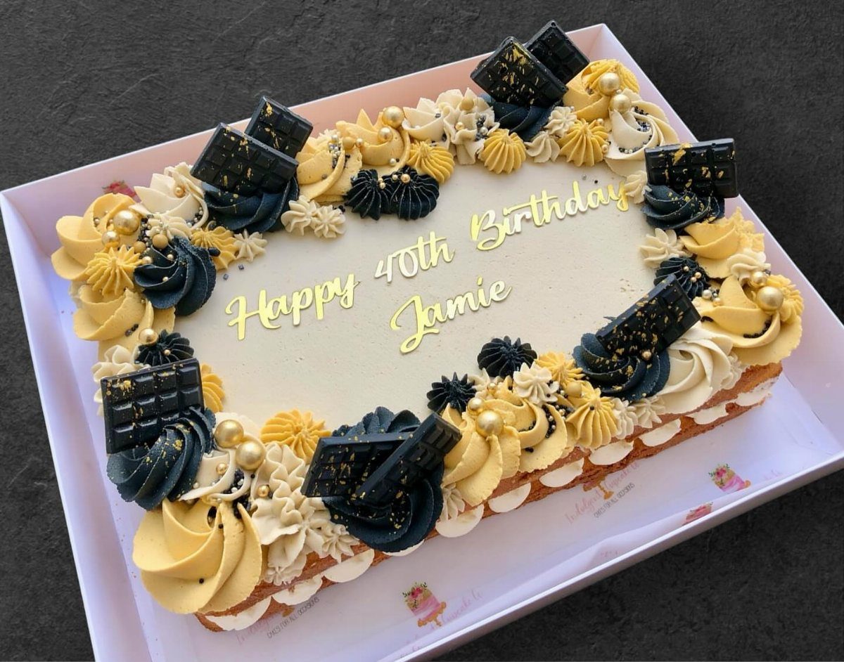 Rectangular 40th birthday sheet cake with yellow and blue frosting and chocolate bars.