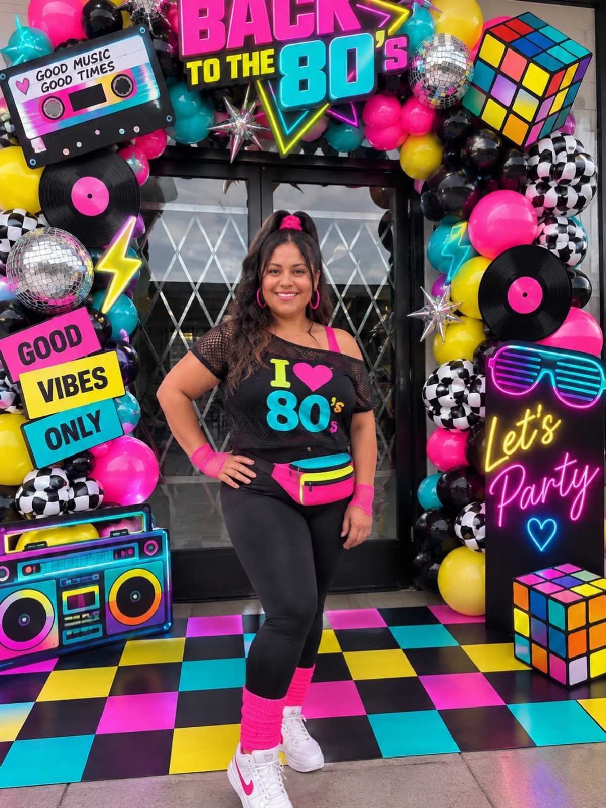 Woman in 80s retro outfit posing before a neon themed party backdrop.