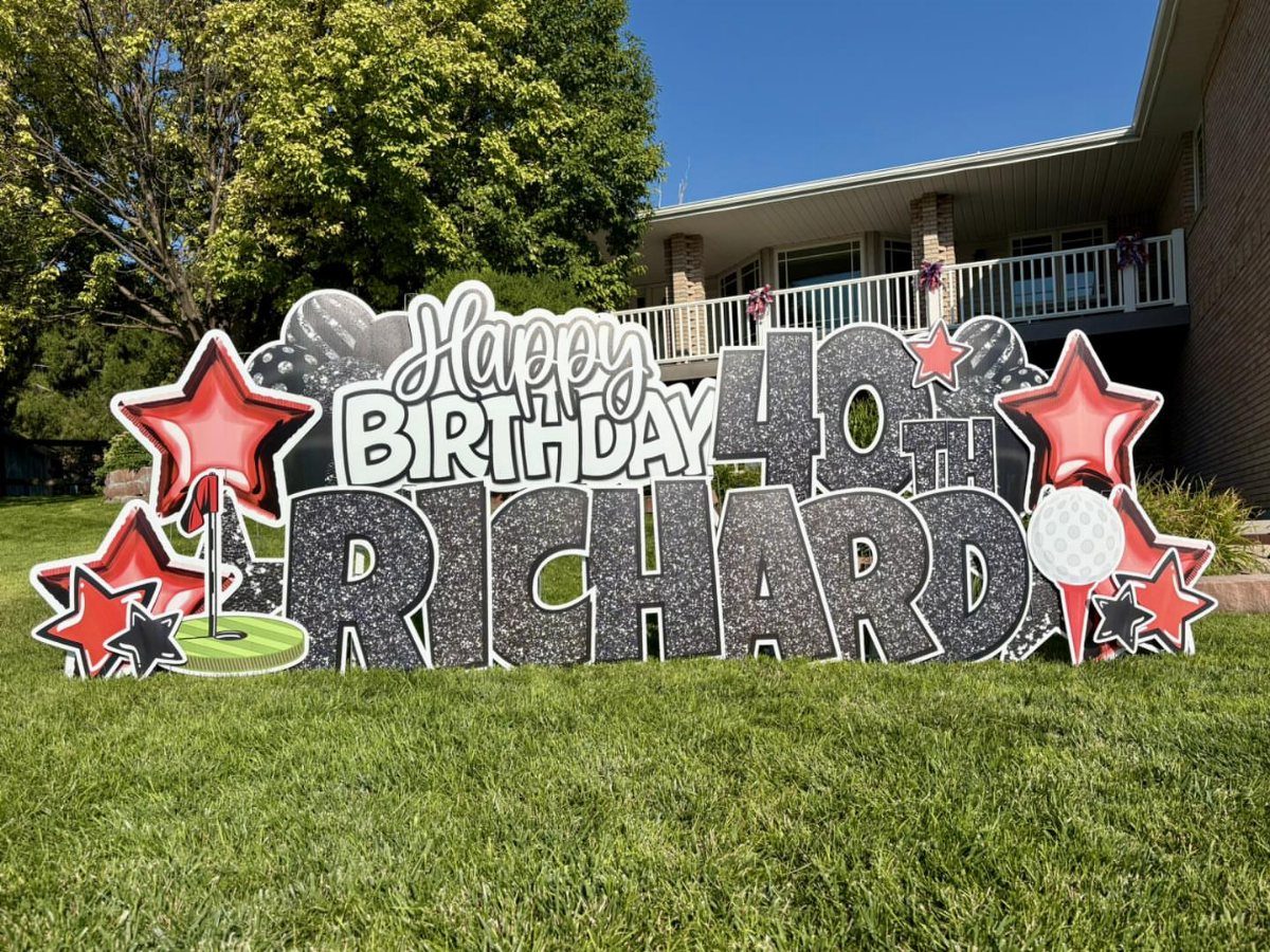 Custom 40th birthday welcome sign for Richard with red stars on green grass