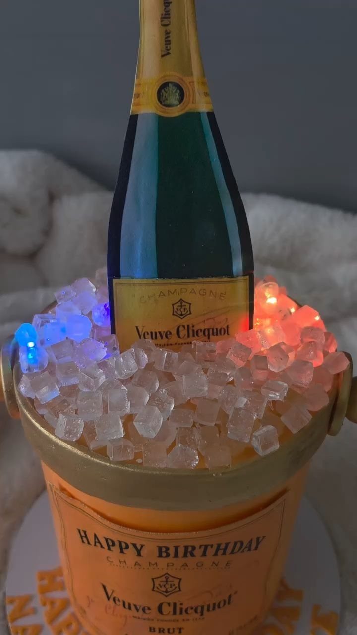 Champagne bucket cake with a Veuve Clicquot bottle and glowing ice cubes.