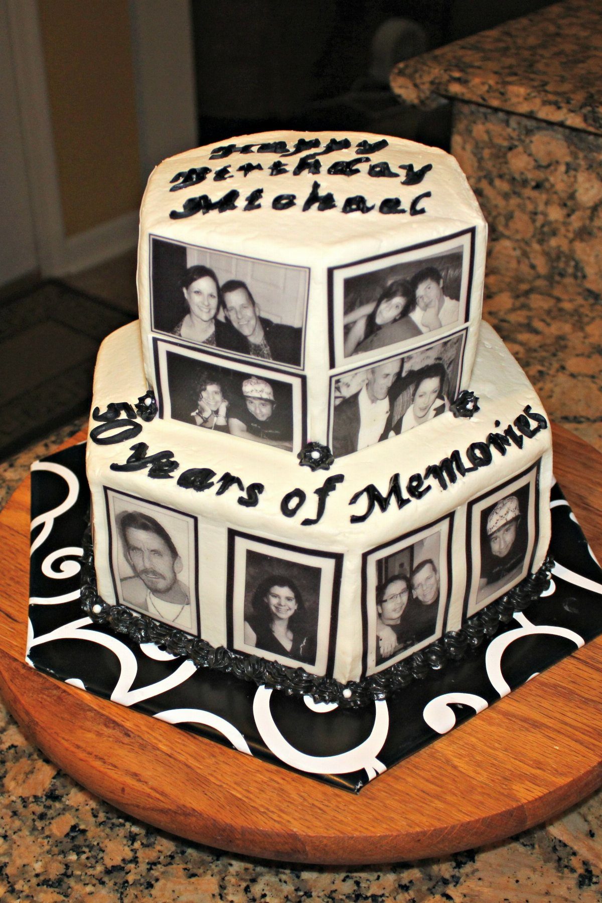 Two-tier white birthday cake featuring edible black and white photos and memory-themed text.