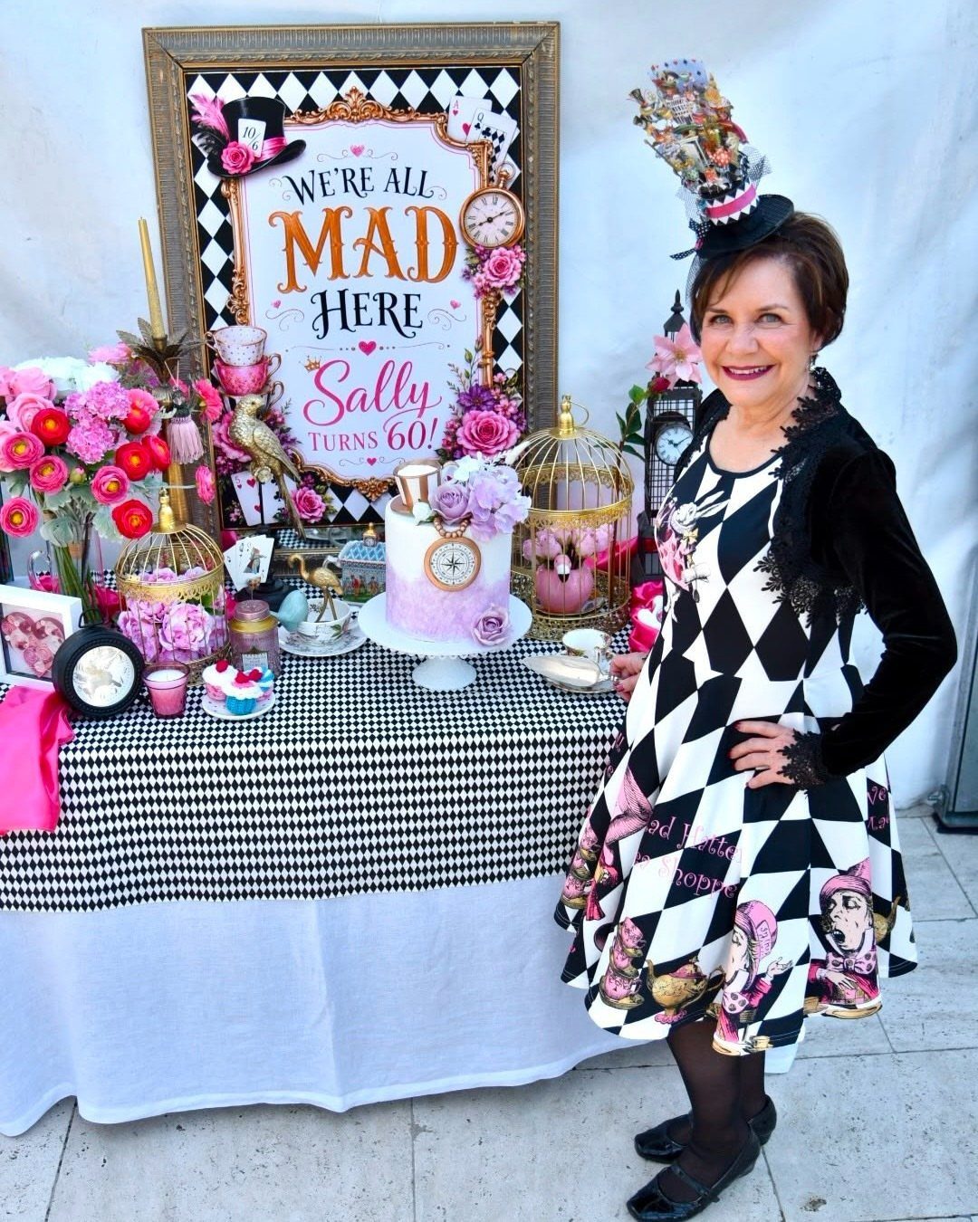 Woman in diamond-patterned dress and black jacket at a 60th birthday party
