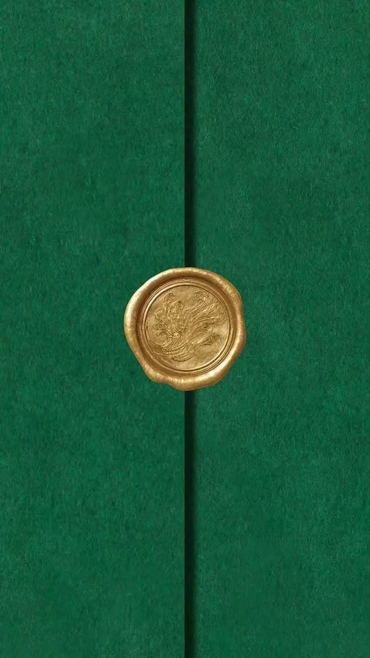 Green textured invitation folder sealed with a gold wax floral seal