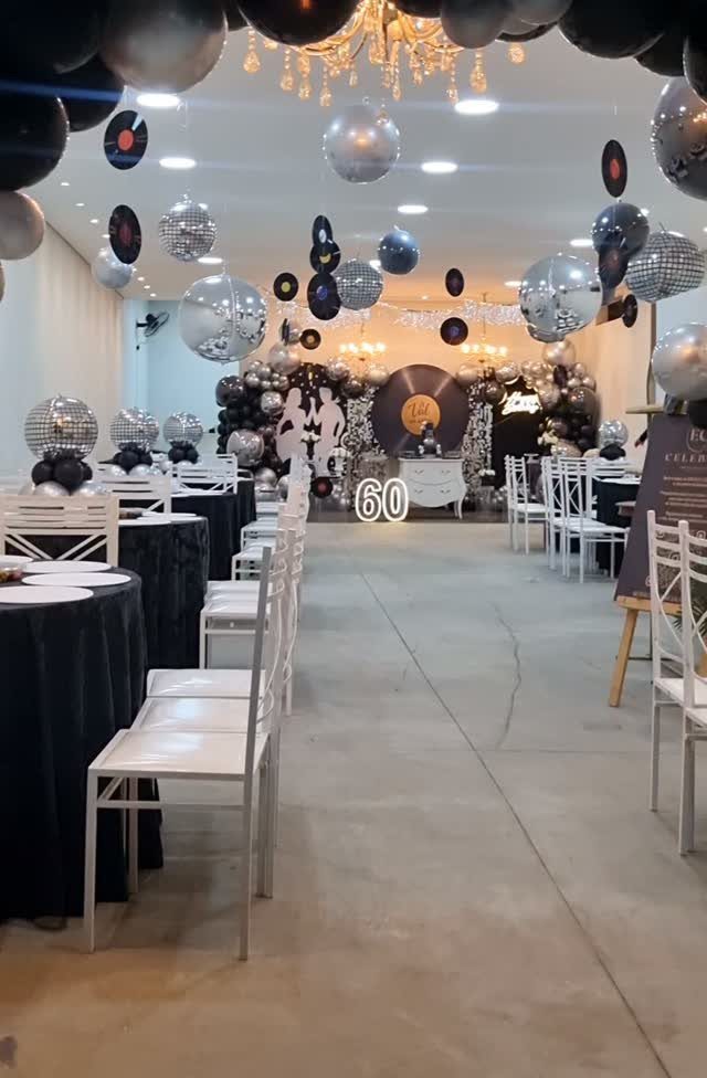 Event space decorated with disco balls, vinyl records, and a large number 60.