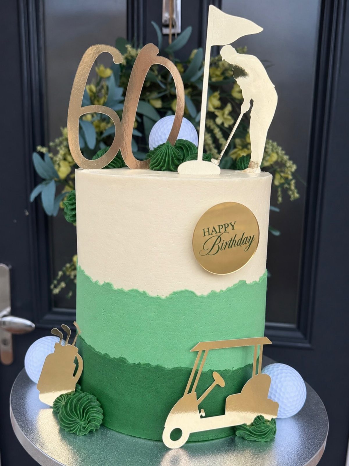Golf themed birthday cake with gold toppers and green frosting for a 60th birthday.