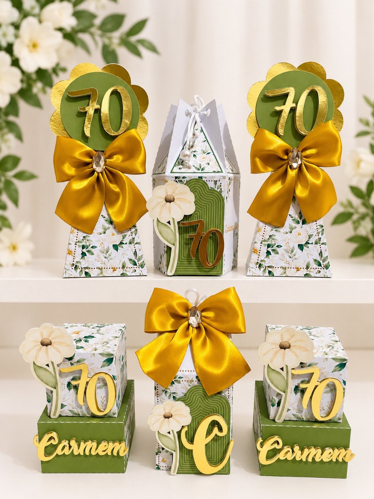 Decorative 70th birthday gift boxes with gold ribbons and floral patterns on white shelf