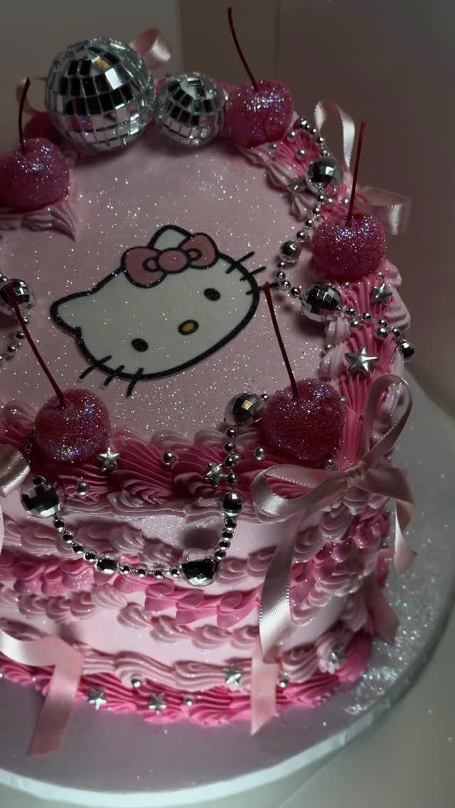 Pink Hello Kitty cake decorated with glittery cherries and small disco balls