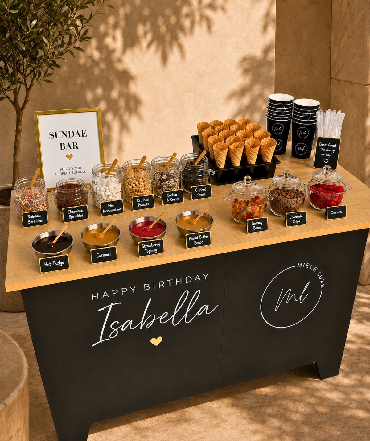 Sundae bar with various toppings, sauces, and waffle cones for Isabella's birthday party.