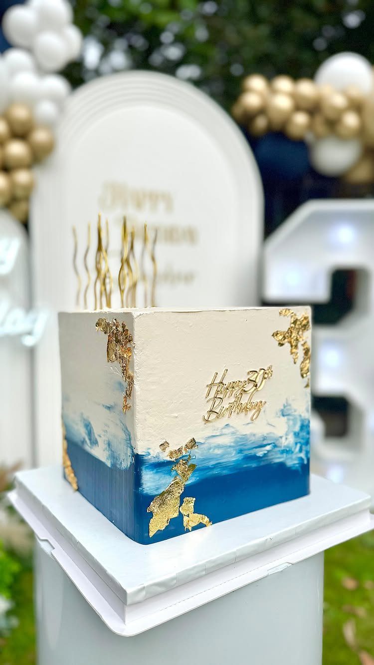 Square white cake with blue ombre gradient and gold leaf for 30th birthday.