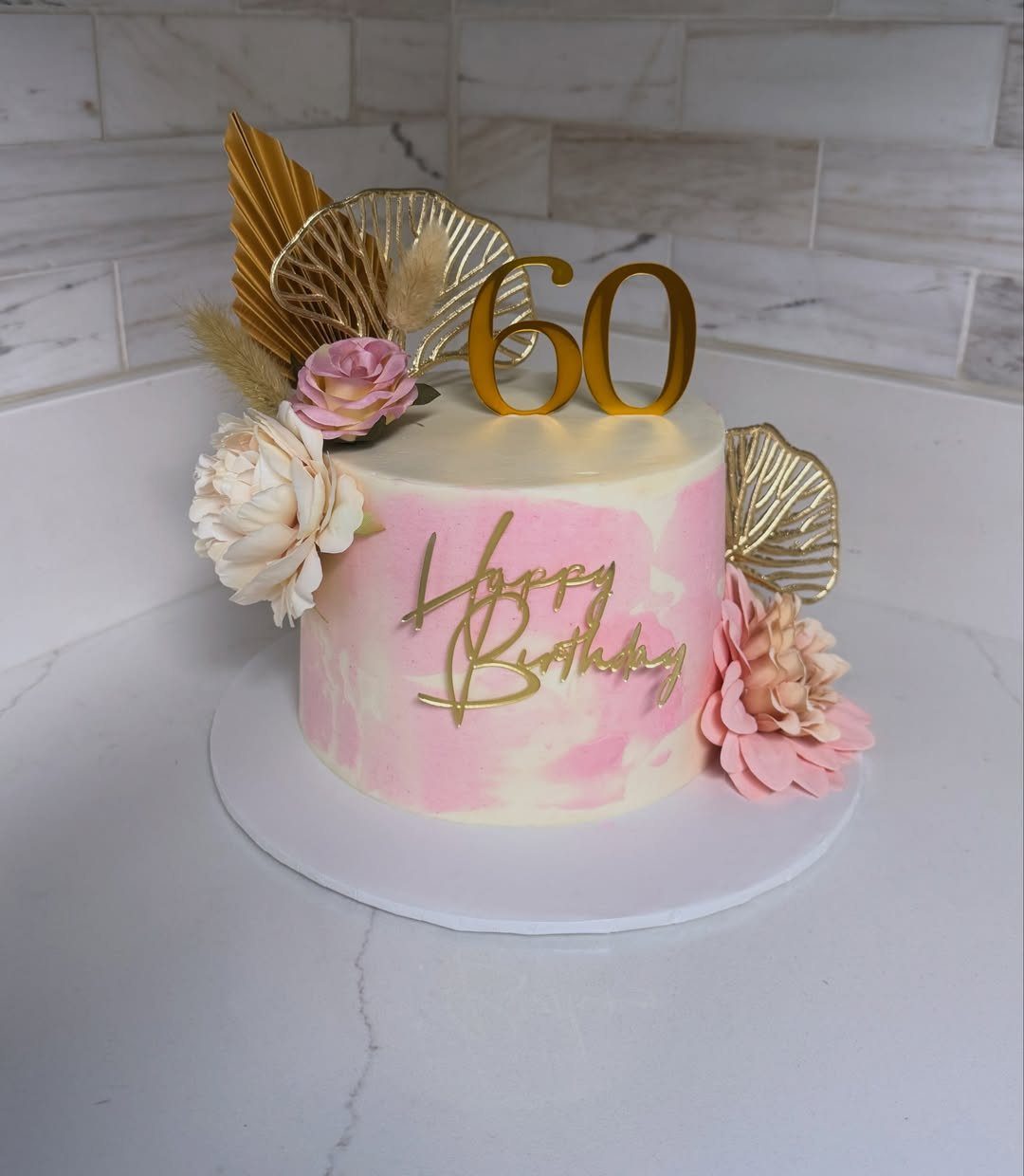 Pink watercolor birthday cake with gold 60 topper and sugar flowers