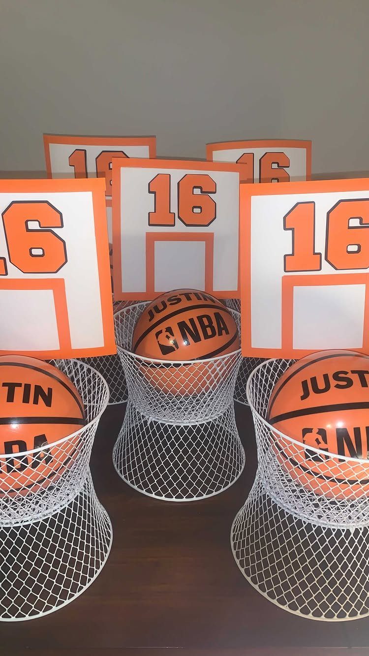 Basketball-themed 16th birthday party favors with mini basketballs in white nets.