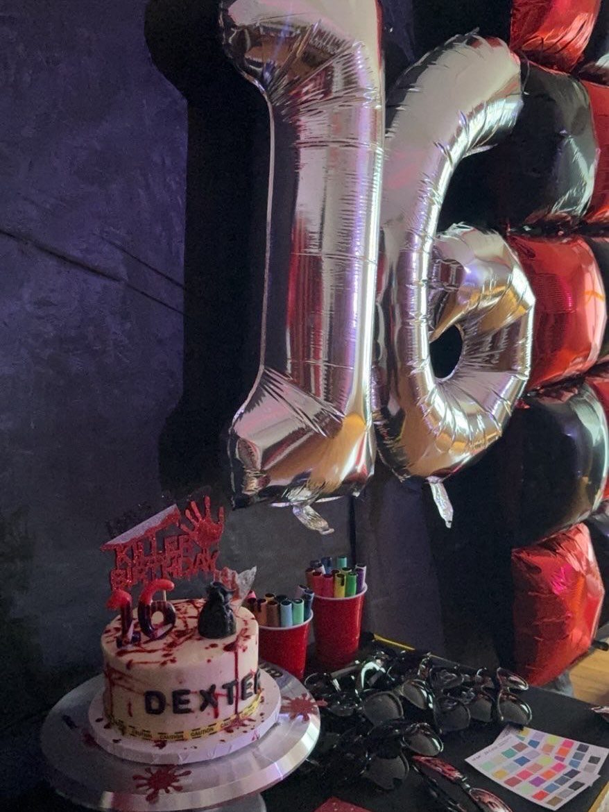 Silver number 16 balloons and a blood-splattered cake for a Dexter themed birthday.
