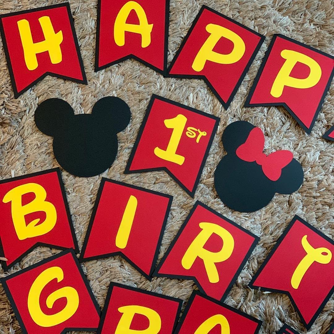 Red and yellow birthday banner with Mickey and Minnie Mouse head silhouettes.