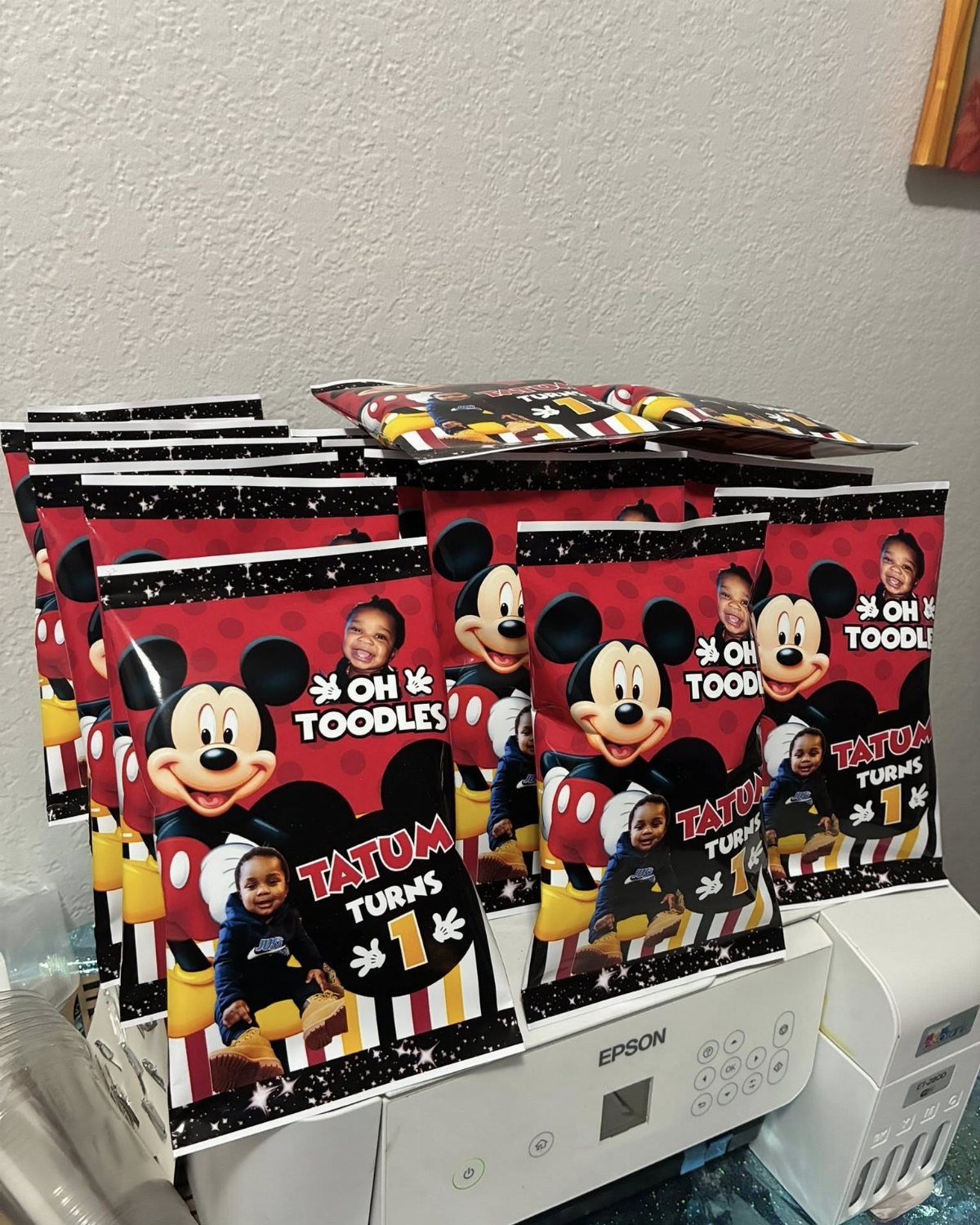 Mickey Mouse themed party favor bags with a child's photo and birthday text.