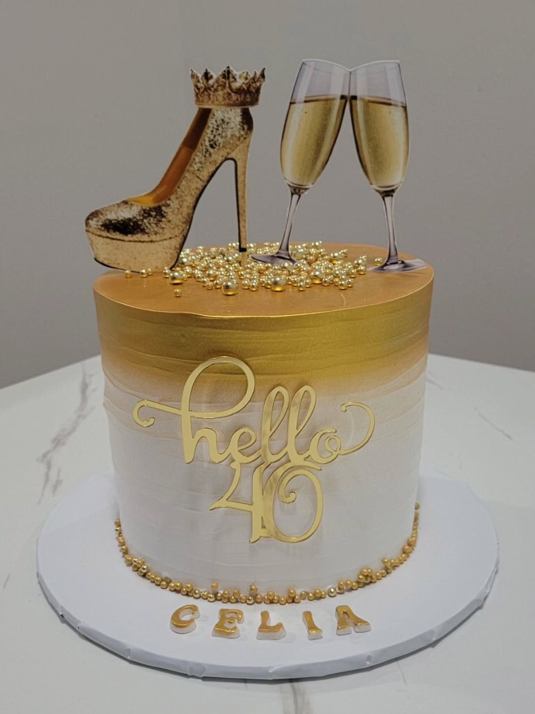 Gold and white ombre 40th birthday cake with high heel and champagne glasses