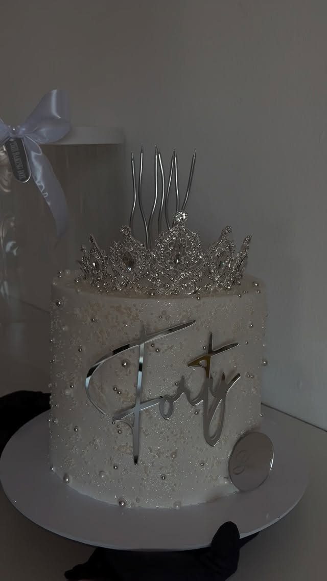 White pearl decorated cake with a silver forty topper and sparkling tiara crown