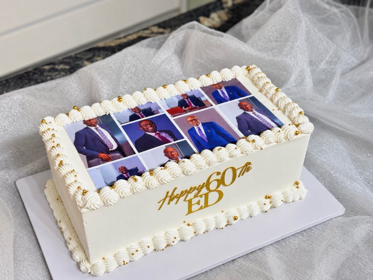 White sheet cake featuring edible photos of a man and gold 60th birthday text.
