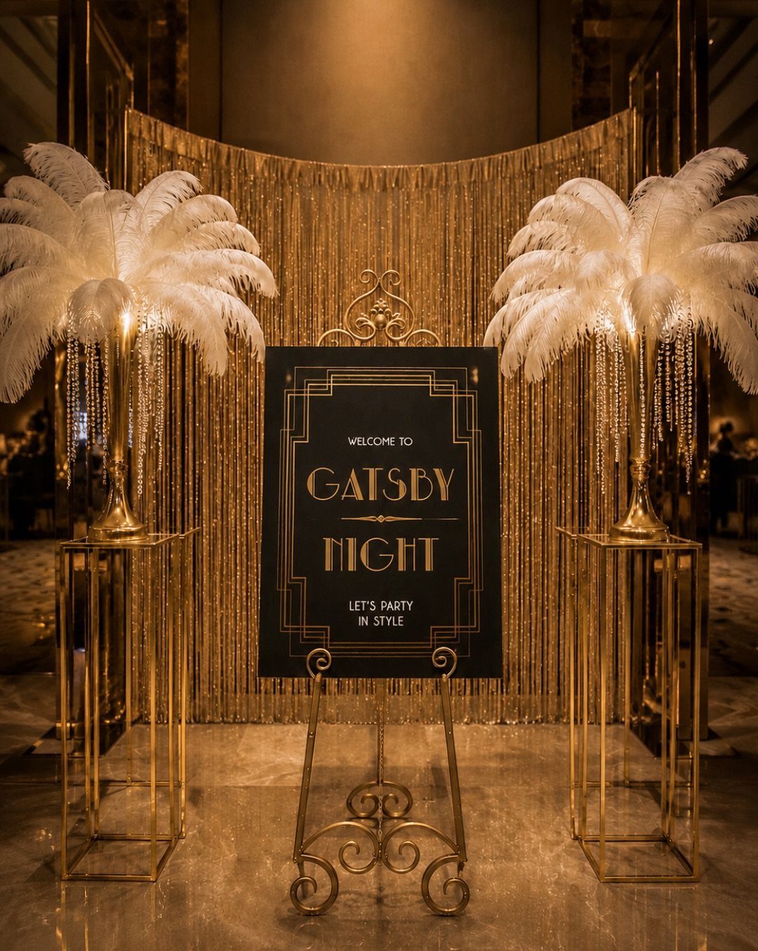 Gatsby Night welcome sign with white ostrich feathers and gold decorations.