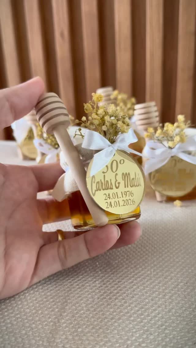 Small honey jar party favor with a gold 50th birthday tag and bow.