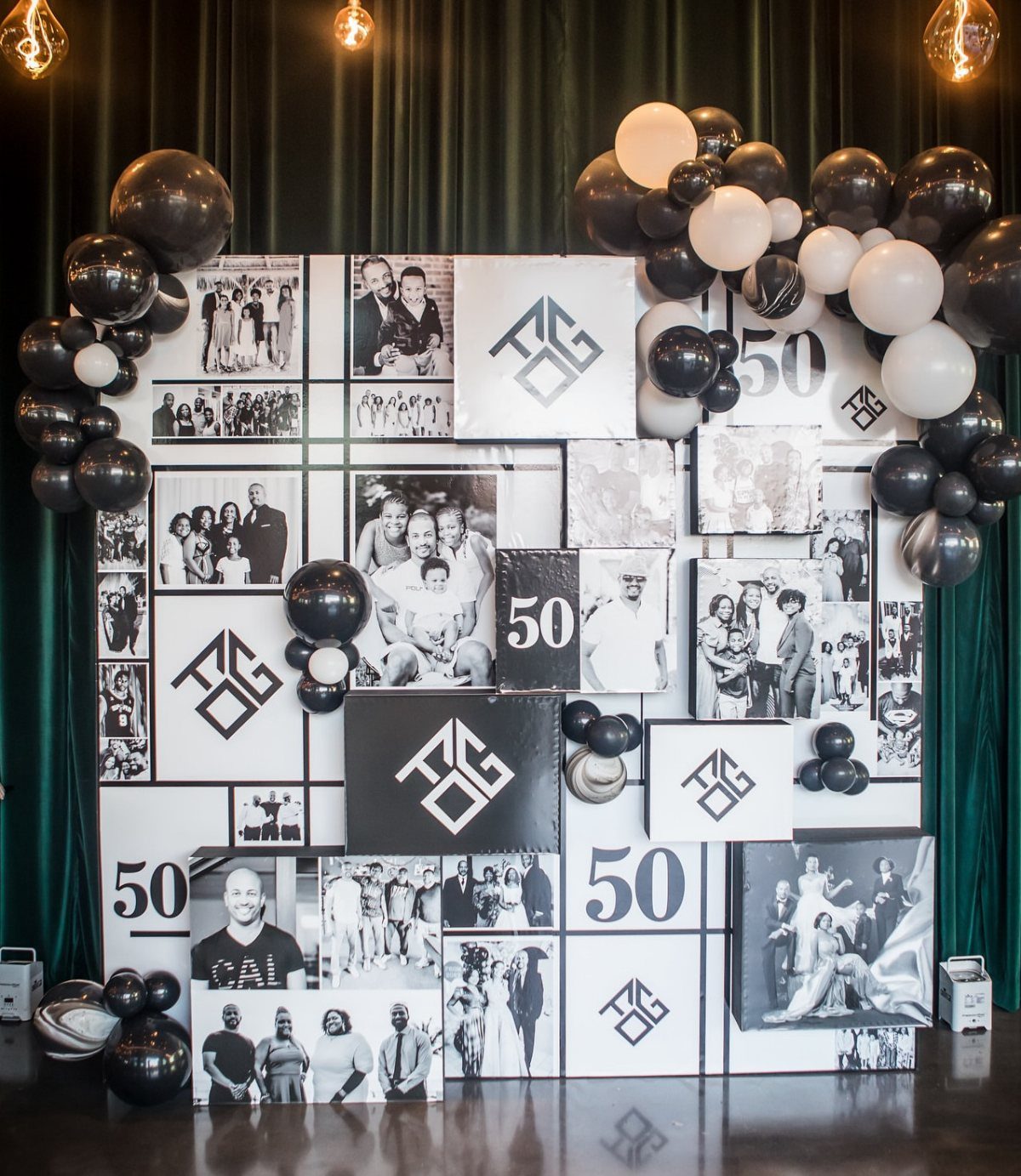 Celebratory photo wall with black and white pictures, number 50, and balloons.