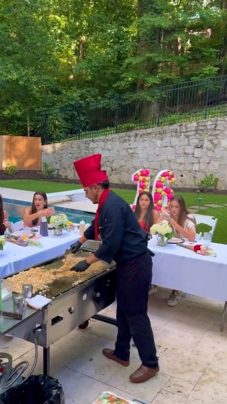 Chef cooking on a grill for teenage girls at a sweet 16 party.