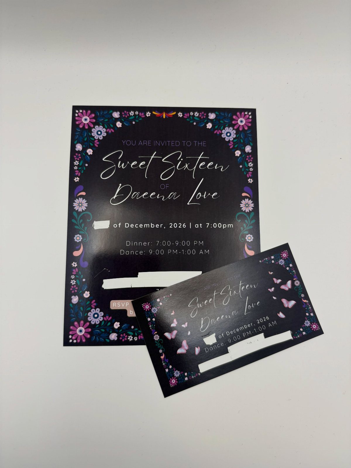 Black sweet sixteen invitations with floral borders and purple butterfly accents on white background