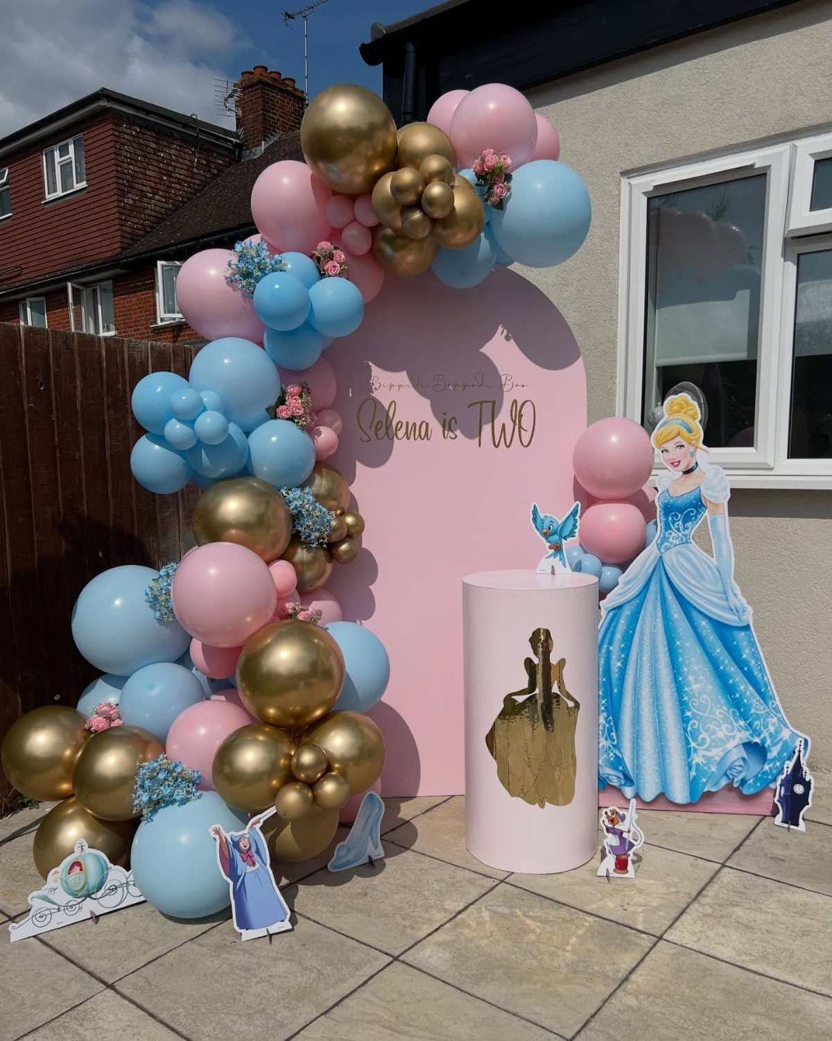 Cinderella themed birthday party setup with pink and blue balloons and Cinderella cutout