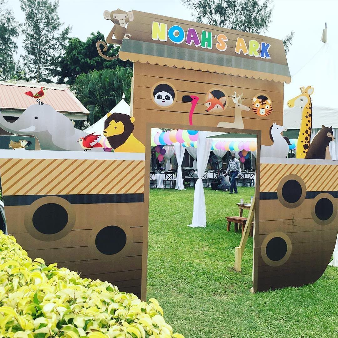 Noah's Ark cardboard cutout with animal figures and a pink number two on grass